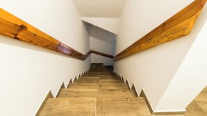 A staircase with wooden handrails and a white interior. - Old Town Harmony Studio (Poznań)