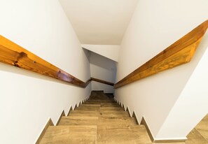 A staircase with wooden handrails and a white interior. - Old Town Harmony Studio (Poznań)