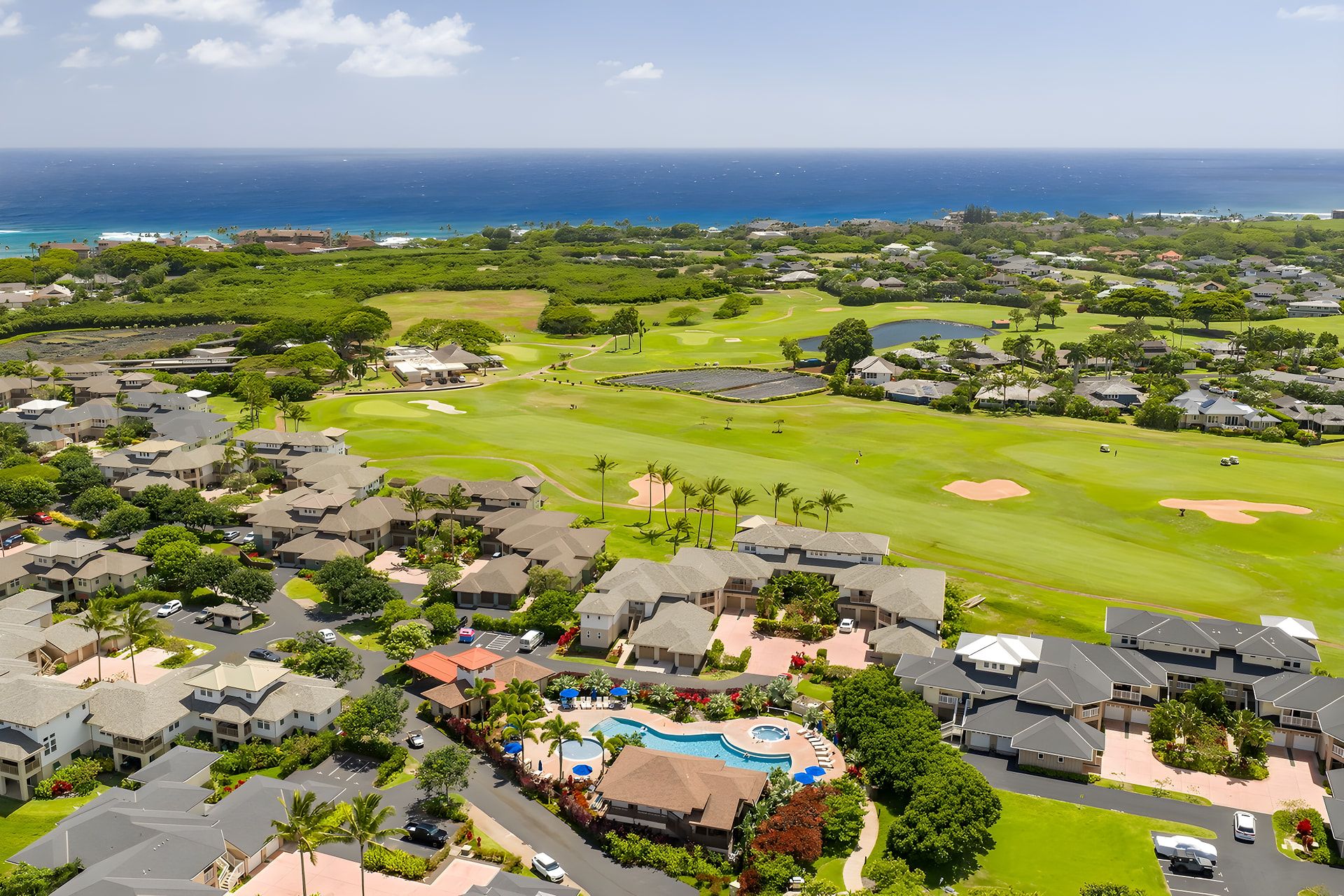 A golf course with a swimming pool and residential buildings.