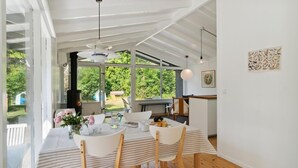 A dining area with a table, chairs, a hanging light fixture, and a view of the outdoors. - Lovely home in Vejby with WiFi (Vejby)