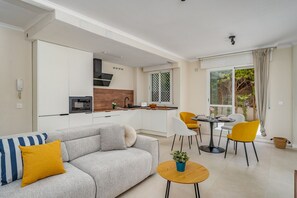 A modern apartment with a living room, dining area, and kitchen. - Brisa de Banús by Lica Homes (Marbella)