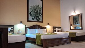 A hotel room with two beds, a large painting on the wall, and a mirror above the bed. - jasmin villa ayurveda resort (Negombo)