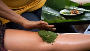 A person applying a green substance to another person's arm. - jasmin villa ayurveda resort (Negombo)