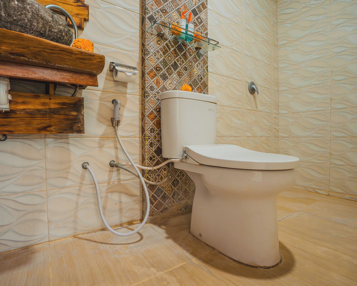 A bathroom with a toilet, shower, and a shelf with toiletries.