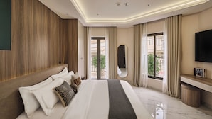 A modern hotel room with a large bed, a TV, a mirror, and a view of the outside. - Luckin Hotel (Ho Chi Minh City)