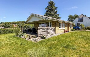 A single-story house with a covered patio, a stone foundation, and a small garden area. - 2 bedroom stunning home in Broager (Broager)
