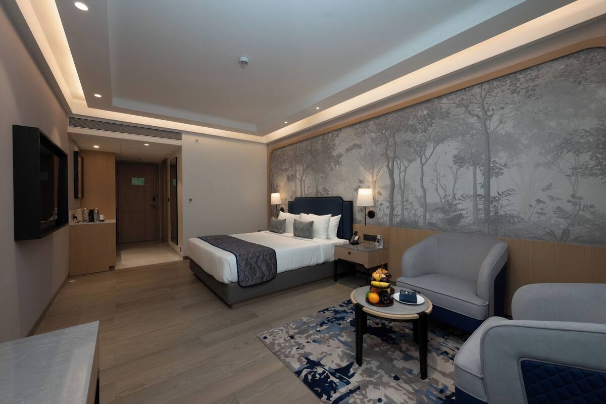 Habitación Deluxe | Ropa de cama de alta calidad y minibar