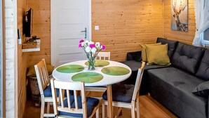 A wooden interior with a round table, chairs, a sofa, and a door. - Awesome home in Radkow with WiFi (Radkow)