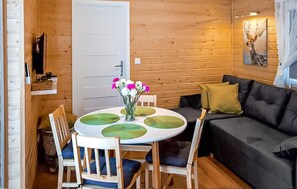 A wooden interior with a round table, chairs, a sofa, and a door. - Awesome home in Radkow with WiFi (Radkow)