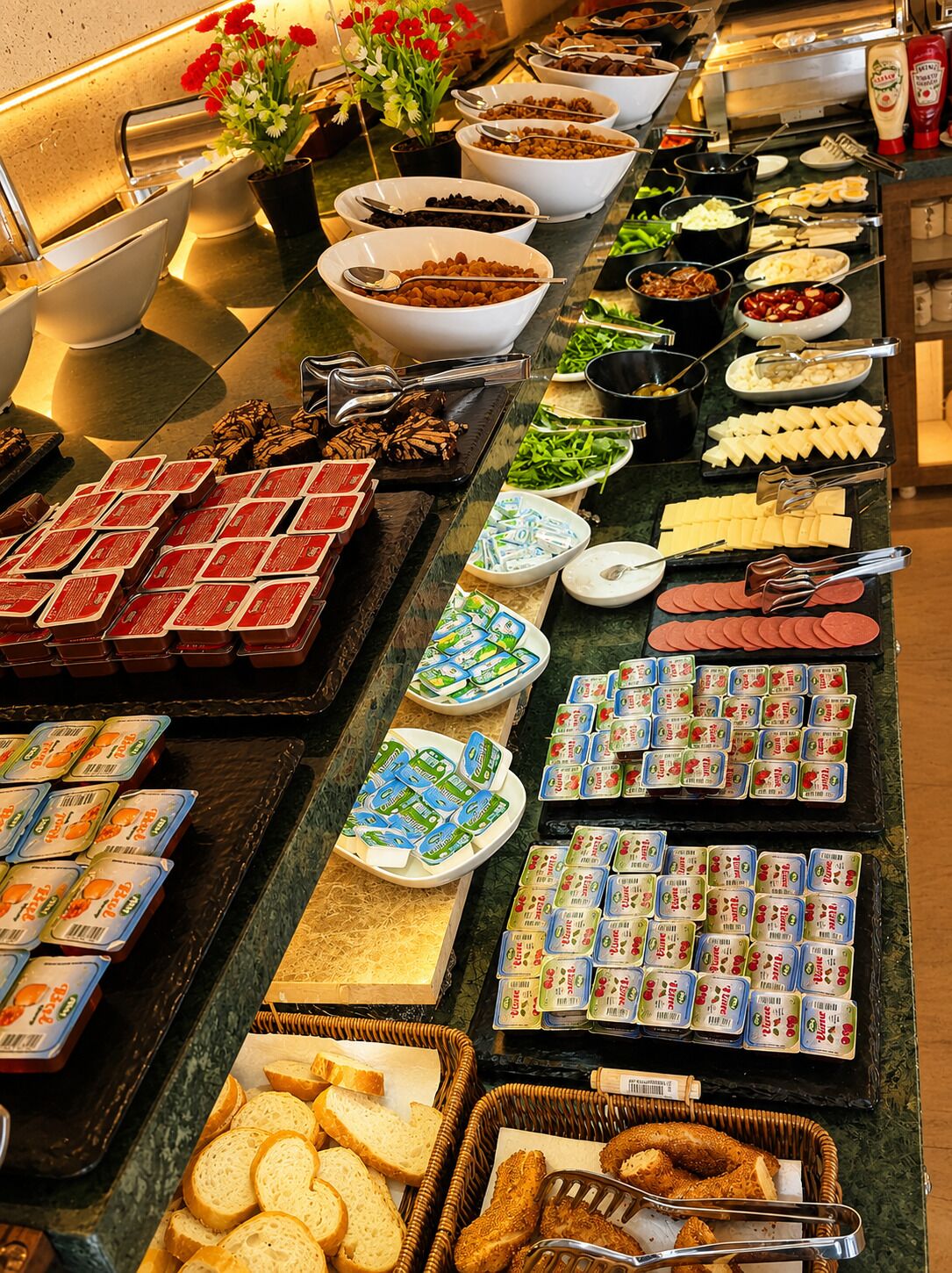 A buffet with various food items and condiments.