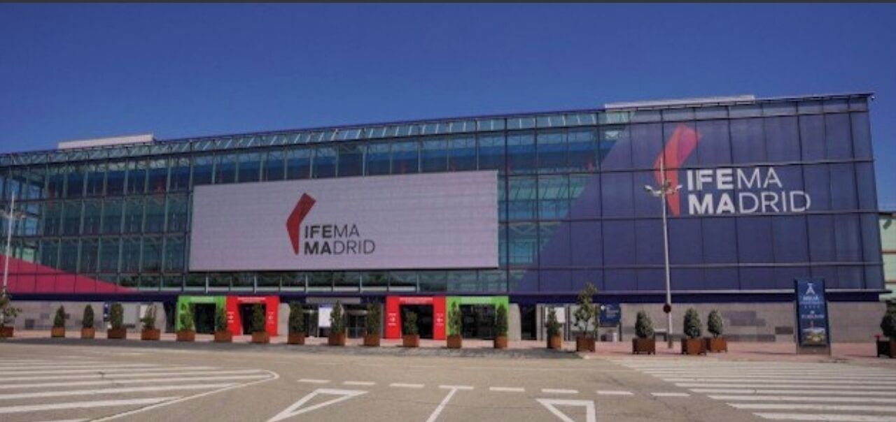 A modern building with large glass windows and a prominent IFEMA MADRID sign.