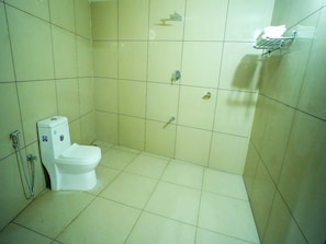 A small, clean bathroom with a toilet, a shower, and a towel rack. - Hotel O Erumeli Bus Terminal Kottayam (Kanjirappally)