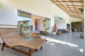 A spacious living area with a large wicker chair, a glass coffee table, and a sofa set. - Bingin Villas: Luxury, Concierge &  Security (Badung)