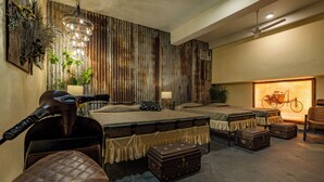 A room with bunk beds, a motorcycle, and vintage suitcases.