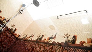 A staircase with patterned walls and a handrail, leading to a room with a geometric floor pattern and a ceiling with a star-like design. - Rokky Hill Cottage Ella (Ella)