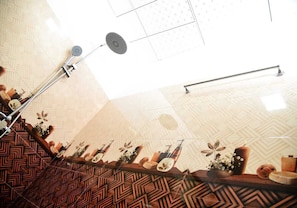 A staircase with patterned walls and a handrail, leading to a room with a geometric floor pattern and a ceiling with a star-like design. - Rokky Hill Cottage Ella (Ella)
