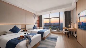 A hotel room with two beds, a desk, a chair, a TV, and a large window with a city view.