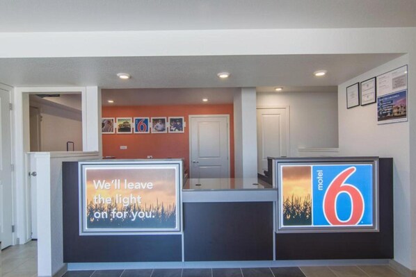 A reception area with a sign that reads 'We'll leave the light on for you.'