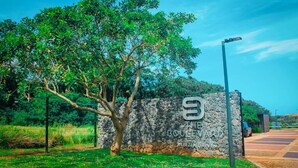 A stone wall with a sign for 'The Boulevard' in a landscaped area with a tree and a street lamp. - Zimbali lakes boulevard edge 103 (Ballito)