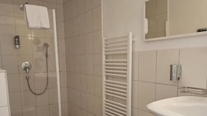 A bathroom with a toilet, shower, and sink. - Hotel Rheinstein (Ruedesheim am Rhein)