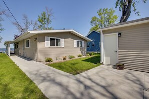 A two-story house with a front porch, a garage, and a small front yard.