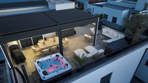 A rooftop patio with a hot tub, outdoor seating, and a view of the city. - Crown Penthouse Čiovo (Okrug Gornji)
