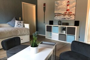 Ein Schlafzimmer mit Bett, Nachttisch und Beistelltisch.
