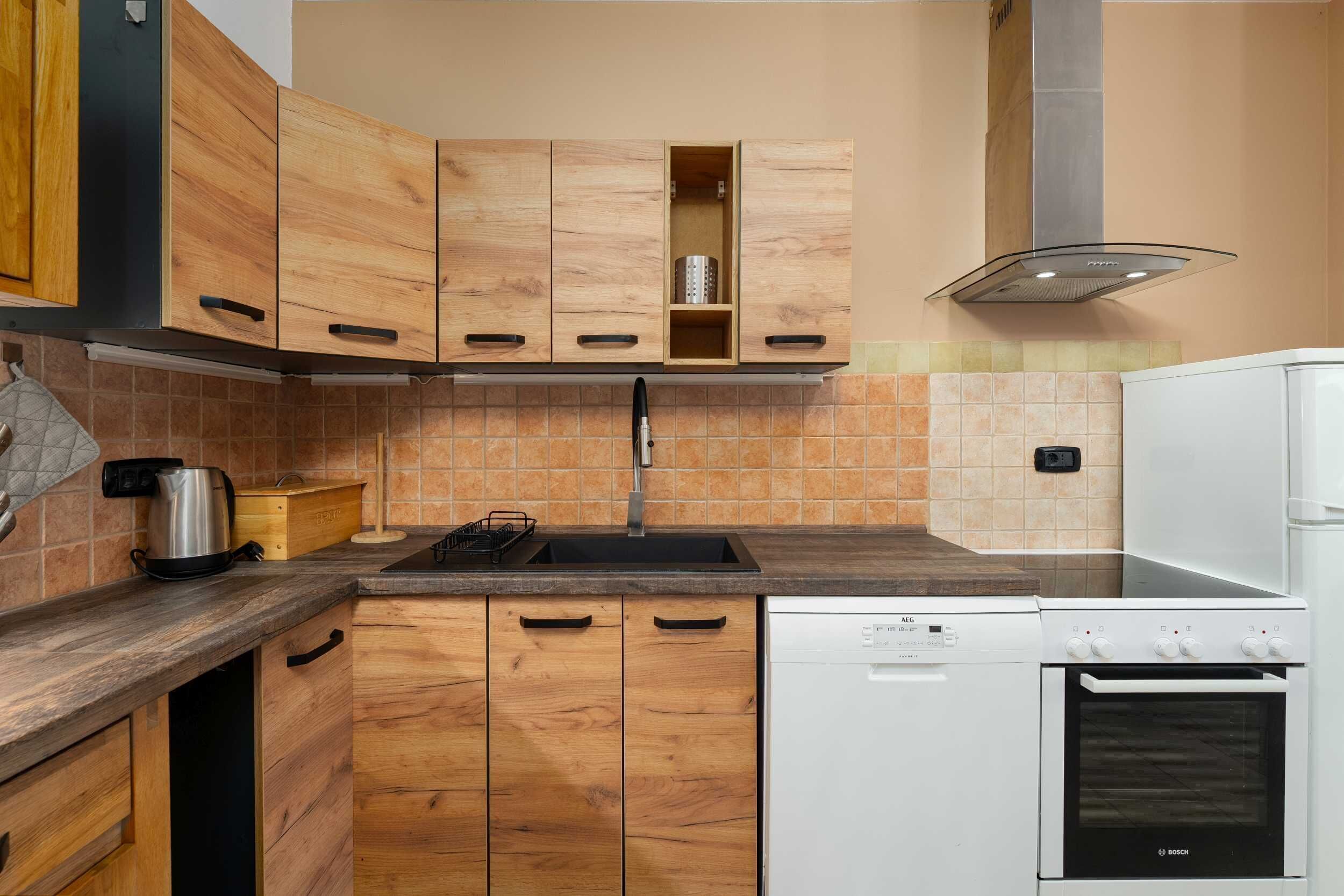 A kitchen with wooden cabinets, a Bosch dishwasher, and a stove.