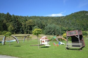 Ein Spielplatz mit Schaukeln, Rutschen und Klettergerüsten.