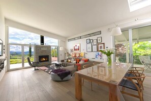 A spacious living area with a fireplace, a dining table, and a sofa set. - Nestled among the gentle hills of San Marcello, where the eye wanders across lush greenery and the silhouette of the mountains, stands a private villa designed for those who wish to slow down, breathe deeply, and enjoy the luxury of time.Offering 500 sqm (San Marcello)