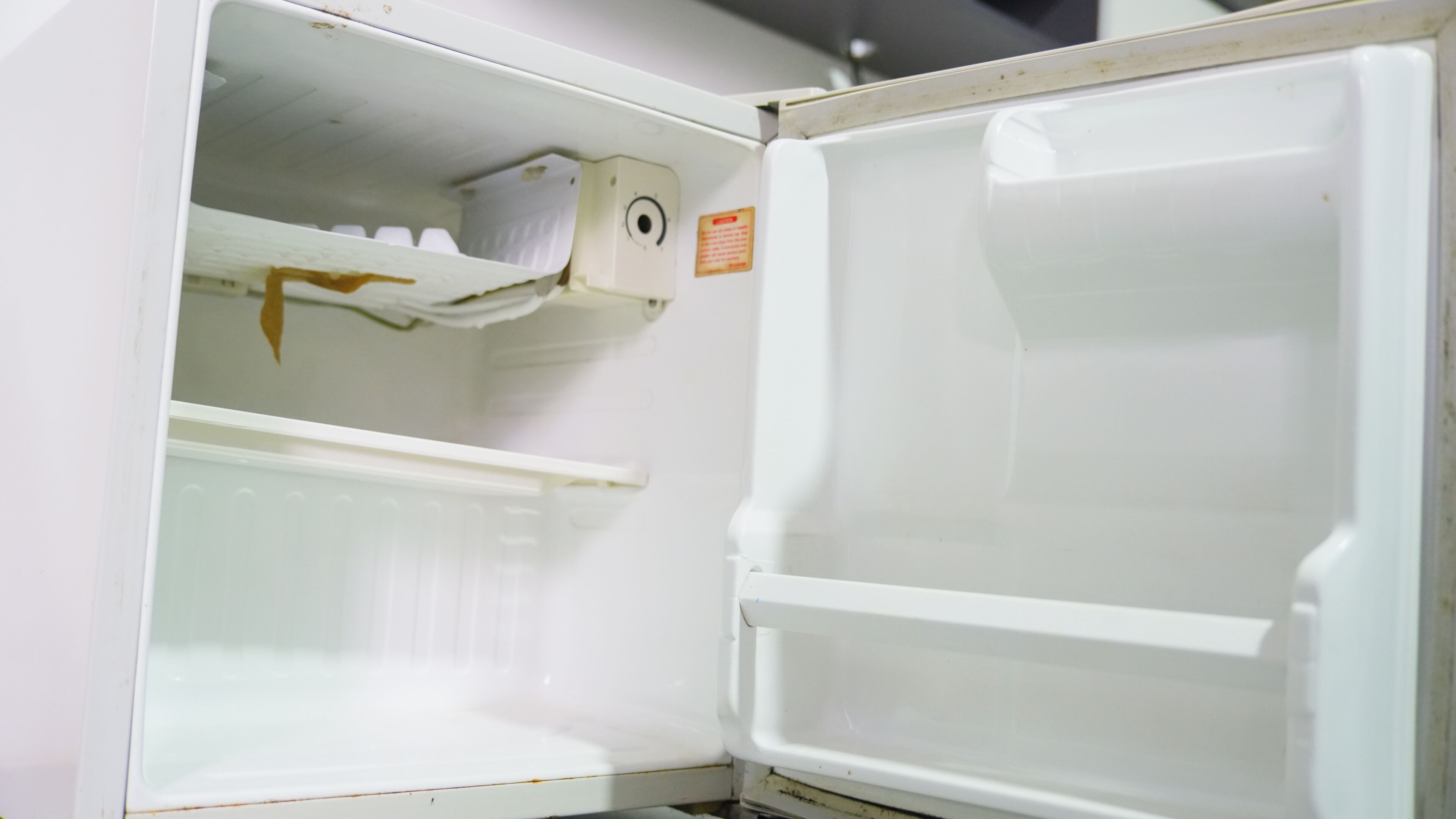 An open refrigerator with shelves and a control panel.