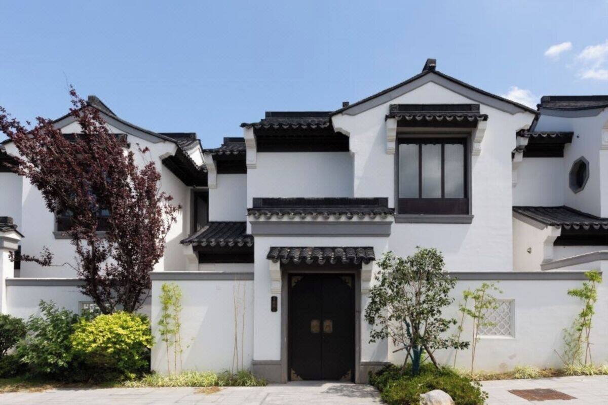 A traditional-style building with a symmetrical facade, a central entrance, and a tiled roof.