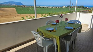 A balcony with a table set for two, overlooking a scenic landscape. - SUN HOUSE MONTORSO-OASIS OF RELAXATION A STONE'S THROW FROM THE SEA (LORETO)