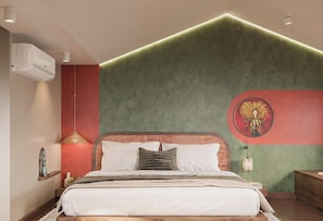 A bedroom with a bed, a wall-mounted air conditioner, a decorative wall piece, and a bedside lamp. - Cocoon Danang Airport Hotel & Apartment (Hoa Cuong)