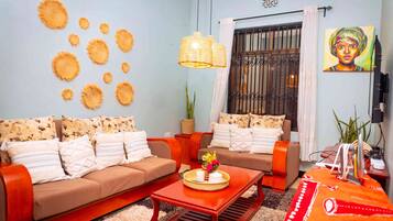 A living room with two sofas, a coffee table, and a TV stand.