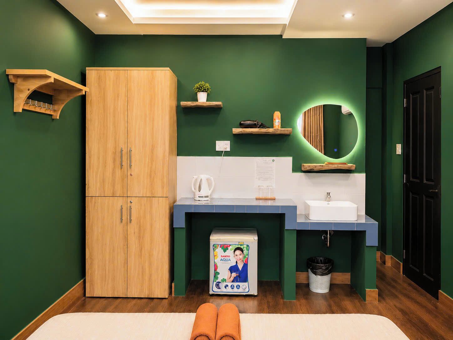 A modern bathroom with a wooden cabinet, a sink, a mirror, and a towel rack.