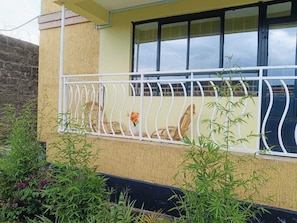 A building with a balcony, a window, and some plants. - Soulful short & long stays in Nakuru, Rooftop views,cozy rooms, peace & purpose. (Nakuru)