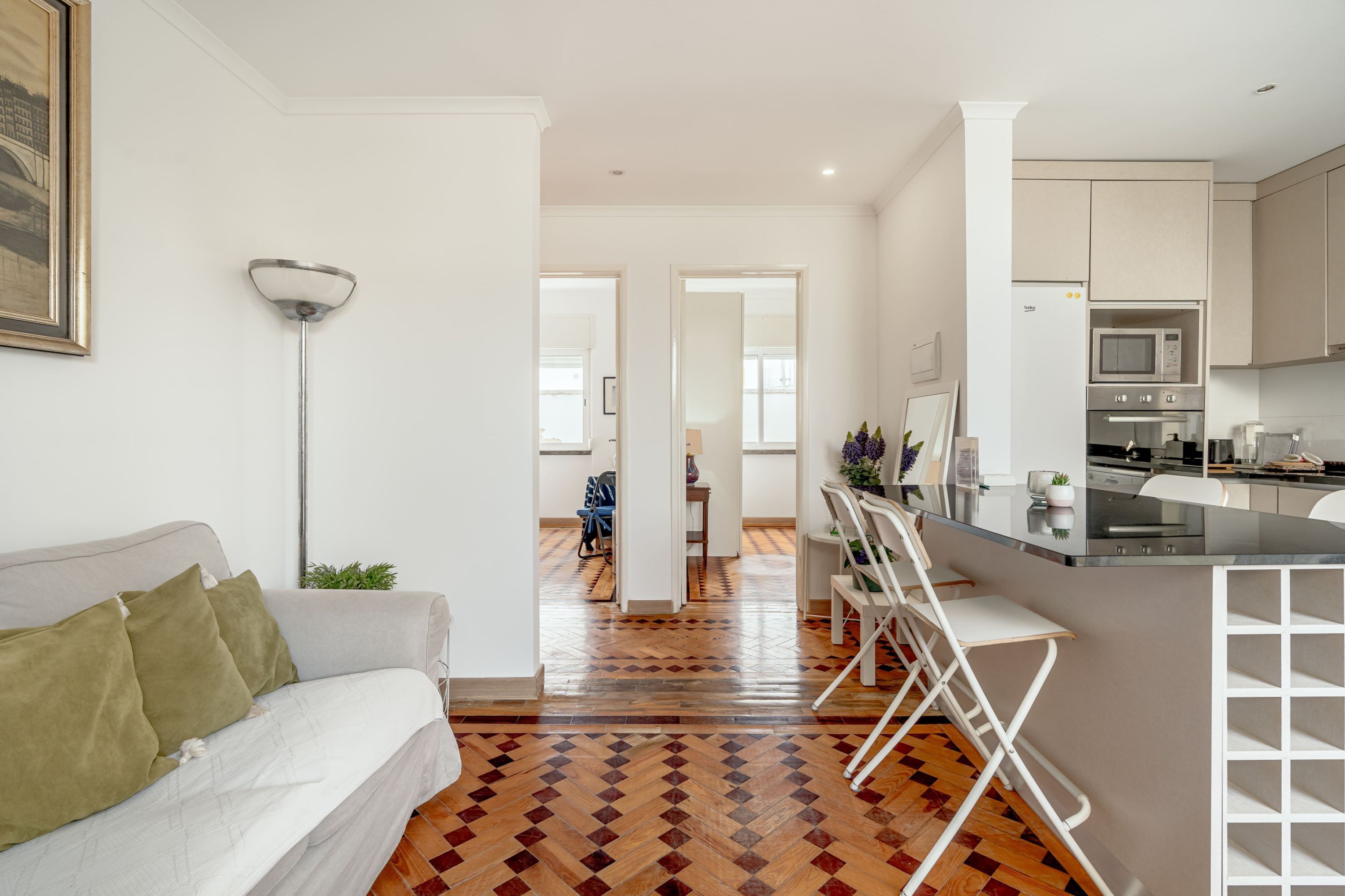 A modern apartment with a living room, kitchen, and dining area.
