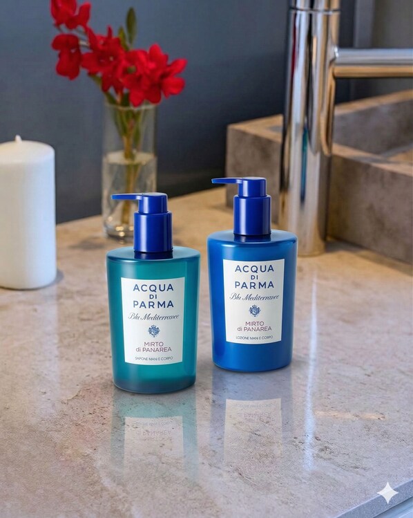Two bottles of Acqua di Parma body wash on a bathroom counter.