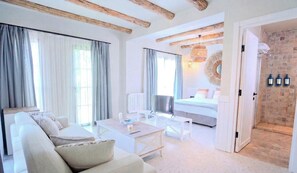 A modern hotel room with a sofa, a dining table, a bed, and a bathroom with a shower. - Vaha Bitez Boutique Hotel (Bodrum)