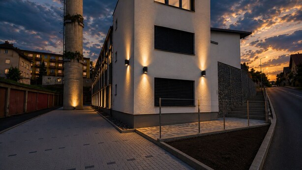 A modern building with a flat roof, large windows, and a paved walkway. - Microbyty & Apartments  (Ústecký kraj)