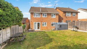 A residential property with a brick house, a wooden fence, a picnic table, and a barbecue grill. - Badger Haven, Apt 3 1st floor self contained apartment in Brackley (Brackley)