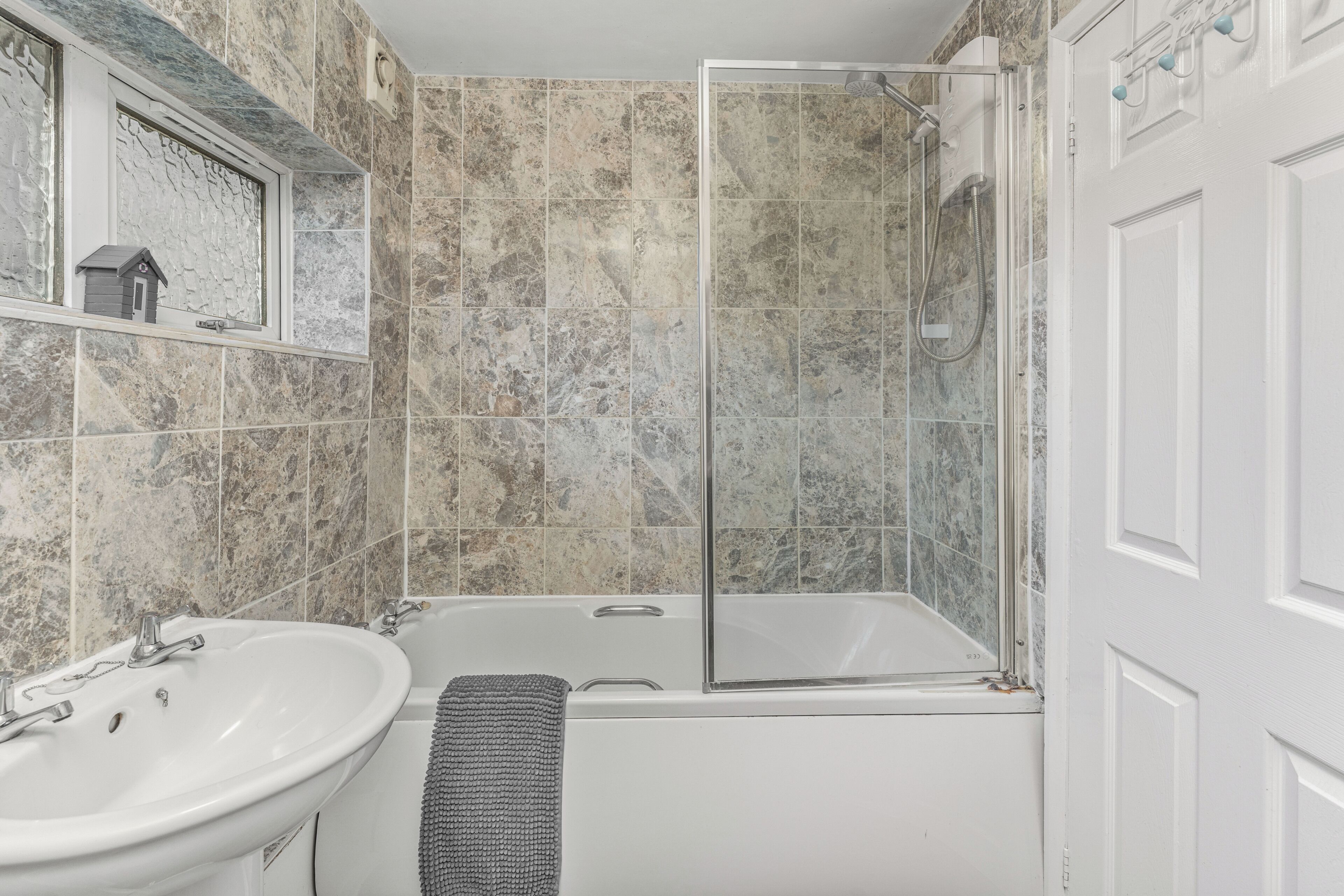 A bathroom with a bathtub, a shower, and a sink.