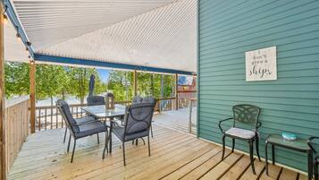 Large covered outdoor living space offering comfortable seating and peaceful views of the surrounding property.