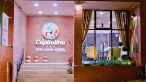 A hotel entrance with a sign reading 'Capitolina' and a staircase leading up to the entrance. - Capitolina (Cluj-Napoca)