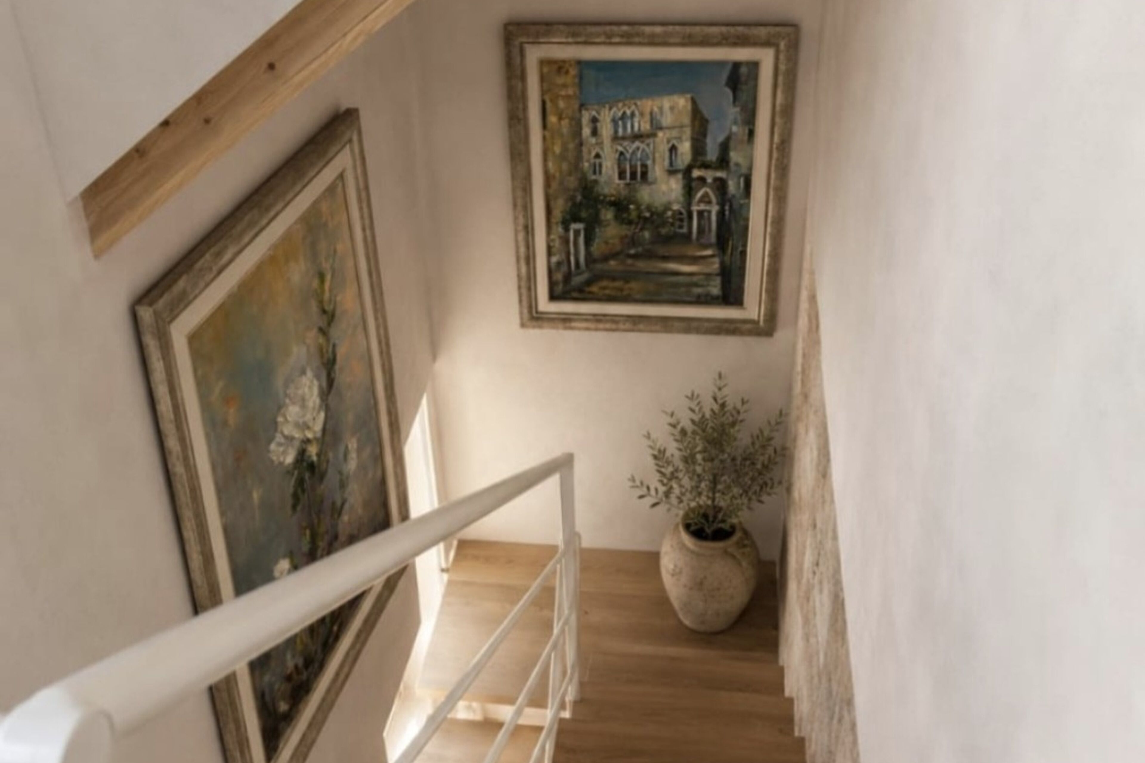 A staircase with a white railing, a painting of a building, and a potted plant.