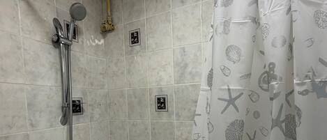 Combined shower/bathtub, deep-soaking bathtub, hair dryer, towels