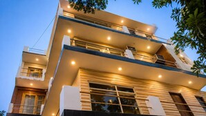 A multi-story building with balconies, large windows, and a modern architectural design. - Govind Residency (Greater Noida)