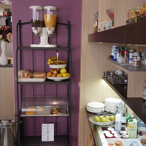 A buffet setup with various food items and condiments.
