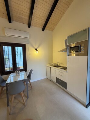 A modern kitchen with a built-in microwave, a dishwasher, and a window with a view.